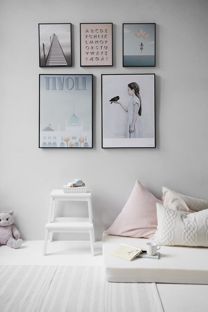 gallery-03 Minimalist Scandinavian bedroom with wall art and cozy decor elements.